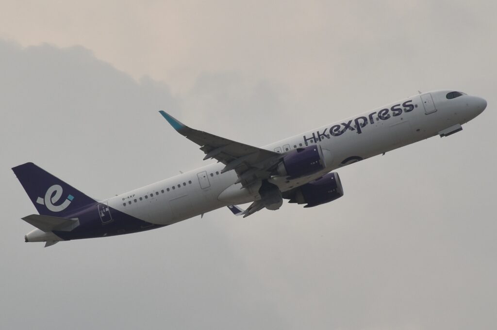 HK Express anniversary sale context: an HK Express aircraft departing Hong Kong airport