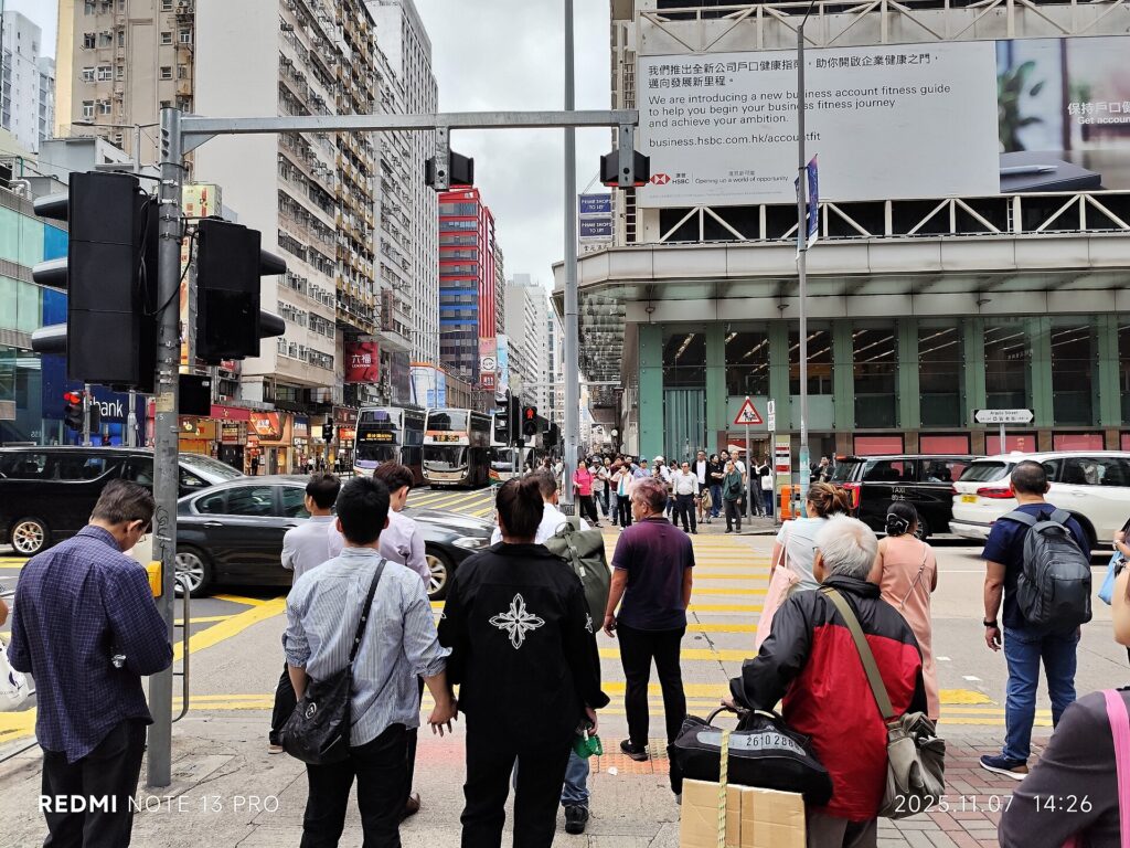 Cars, buses and pedestrians at Nathan Road and Argyle Street in Mong Kok in November 2025